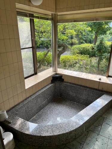 Futo地中海の家的带窗户的浴室设有大浴缸