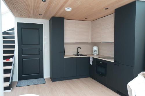 列维Levillas Utsunkulma 10B的厨房配有黑色橱柜和黑色门
