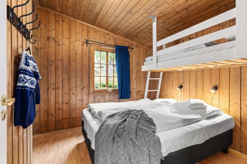 哈山Topcamp Rustberg - Hafjell的木制客房内的1间带1张双层床的卧室