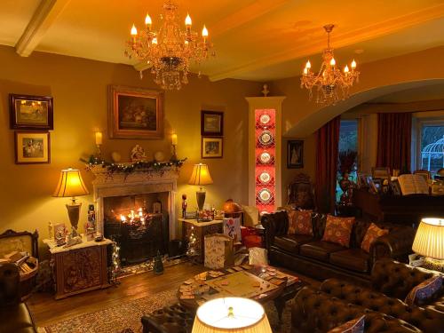 波特马多克Plas Tan-Yr-Allt Historic Country House & Estate的带沙发和壁炉的客厅