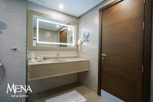 达曼Mena East Suites Dammam的一间带水槽和镜子的浴室