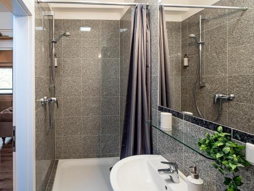 杜伊斯堡Fabelhafte Apartments zum wohlfühlen mit JUNIK Apartments的一间带水槽和淋浴的浴室