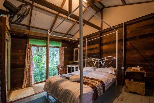 浮罗山背Nature Fruit Farm - Private Estate的一间带床的卧室,位于带窗户的房间内