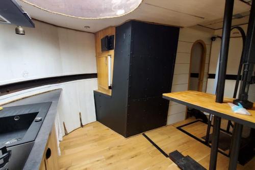 里昂Appartement dans Péniche atypique et idyllique à Confluence的一间厨房,里面装有黑色橱柜