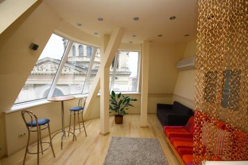 布达佩斯帕尔旅舍和公寓的客厅设有大窗户和沙发
