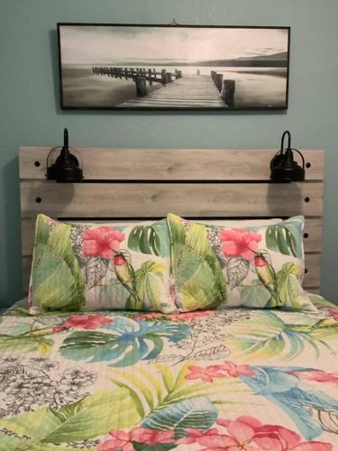 克利尔沃特Cozy Coastal Beach Retreat的一张带两个枕头和木制床头板的床