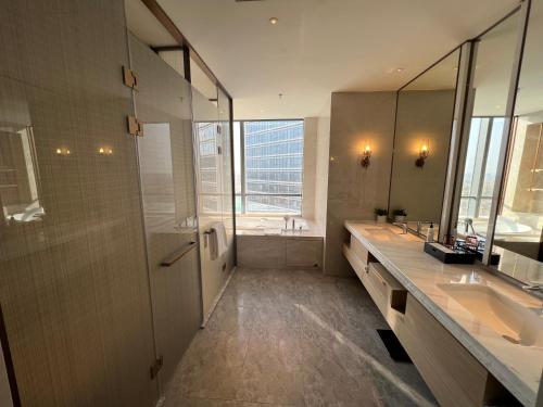 太原山西潇河新城万达锦华酒店的大型浴室设有2个水槽和淋浴。