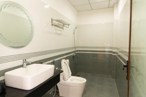 Buôn EnaoKhang Hy Hotel的一间带水槽、卫生间和镜子的浴室