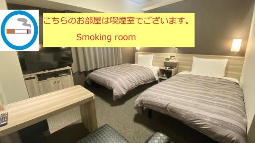 TokaiRoute Inn Grantia Tokai Spa&Relaxation的酒店客房设有两张床和一个可吸烟客房的标志