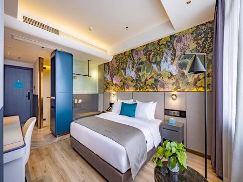 桂林兰欧酒店桂林万福广场的酒店客房设有一张大床和一张书桌。