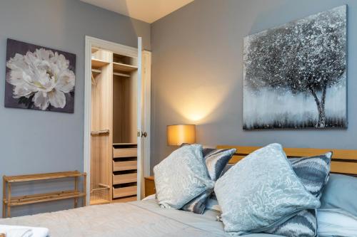 阿伯丁Modern Aberdeen City apartment free parking的一间卧室配有一张带蓝色枕头的床