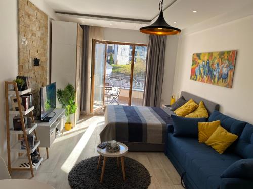 科帕奥尼克Milmari Resort - Apartman L43的客厅配有蓝色的沙发和床。