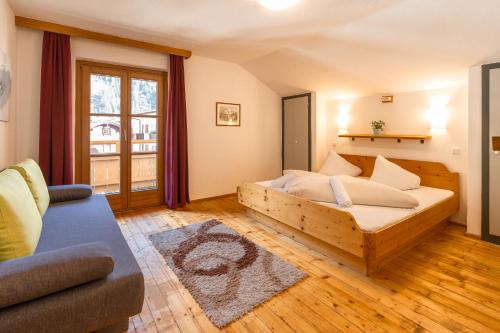 迈尔霍芬das Cityhouse的一间卧室配有一张木床和一张沙发