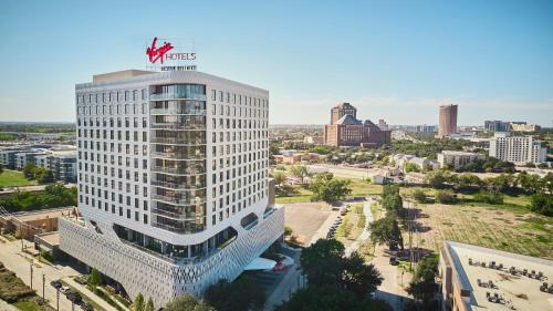 达拉斯Virgin Hotels Dallas的顶部有处女美洲标志的高高的白色建筑