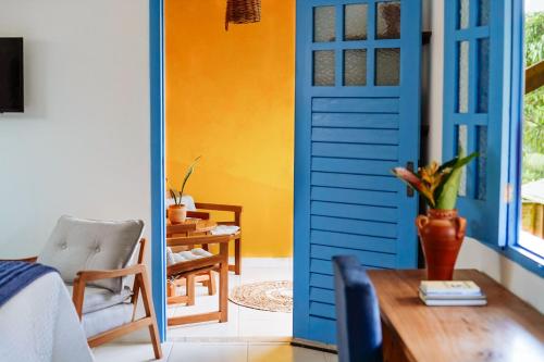 巴拉格兰德Pousada Sabina的一间设有蓝色门和一张桌子的房间