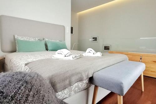 波尔图Typical Quarter Nest的一间卧室配有一张大床和毛巾
