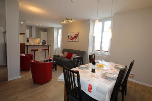 吕兹-圣索沃尔Le Florès Idéalement situé Centre Luz Appart T3 6 personnes Parking的用餐室以及带桌椅的起居室。
