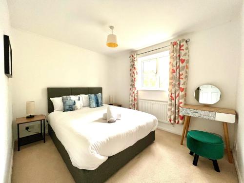 比斯特Comfortable 3 bedroomed house in Bicester的一间卧室设有一张大床和一个窗户。