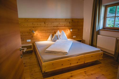 帕尔奇内斯Brünnl's Försterhütte的一间卧室配有一张木墙床
