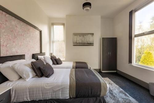 曼彻斯特Midwood Lodge的一间卧室设有两张床和大窗户