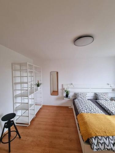 皮耶什佳尼-NEW-Rosetta Apartment的一间卧室设有一张床和一个白色书架