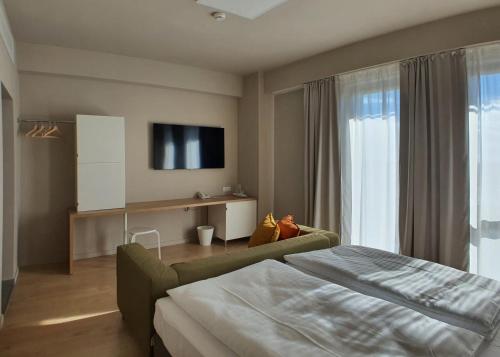 萨图马雷Marida Hotel的一间酒店客房,配有一张床和一台电视