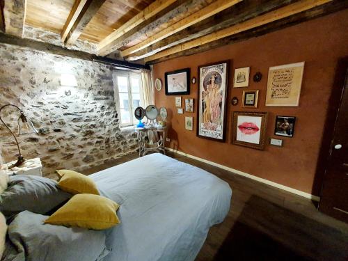 Saint-ChamantGite de la Genevrière的一间卧室设有一张床和石墙