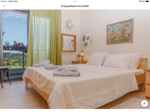 卡桑德里亚Country house with amazing sea view的一间卧室设有一张大床和一个窗户。