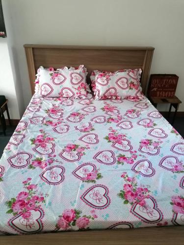 庞普勒穆斯Honey Guesthouse的一张带粉红色的Hello牌毯子和枕头的床