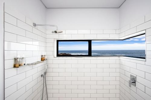 贝蒂湾OnTheRocksBB Solar Powered Guesthouse and Ocean Lodge的海景白色浴室