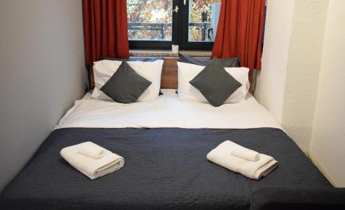 斯科普里M - Square Private Rooms的一间卧室配有一张床,上面有两条毛巾