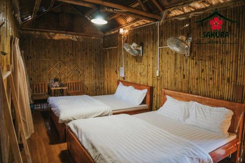 木州县SAKURA House - Vườn Đào的带柳条墙的客房内的两张床