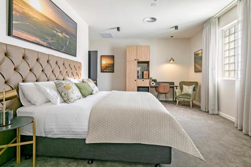 塔南达The Tanunda Club Guest Suites的一间卧室配有一张大床和一张书桌