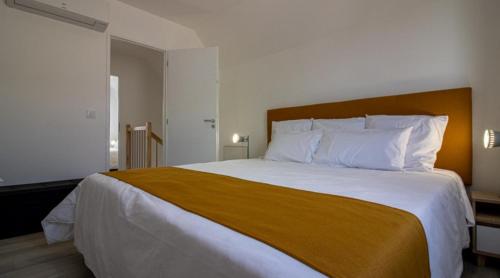 阿热莱斯加佐斯特Gîte l'angélique Fleurs des Pyrénées的卧室配有一张带白色床单和枕头的大床。