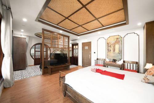 河内Veshia Hotel & Spa的一间卧室配有一张大床和一台平面电视