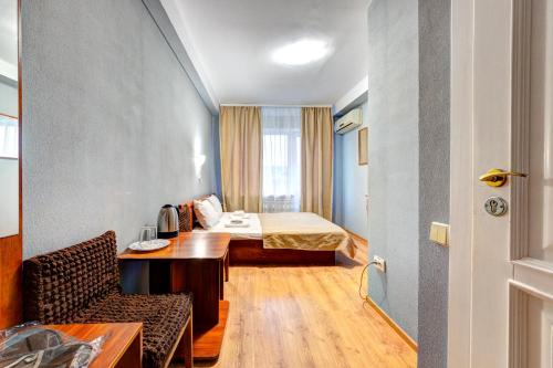 基辅Hotel 7F的配有床、桌子和椅子的房间