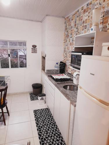 圣塞巴斯蒂安Lindo Flat em Maresias的厨房配有白色冰箱和水槽