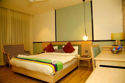 新德里AMARA HOTEL的一间卧室配有一张大床和一张书桌
