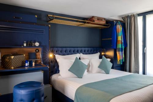 巴黎惠斯勒酒店的一间卧室设有两张带蓝色墙壁的床