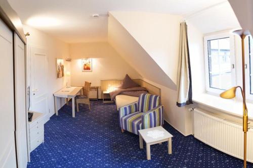 巴特塞森多夫Gästehaus Brinks的配有一张床、一张书桌和一扇窗户的酒店客房