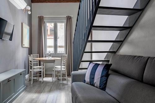 佛罗伦萨numa I Fiore Apartments的客厅设有楼梯、沙发和桌子