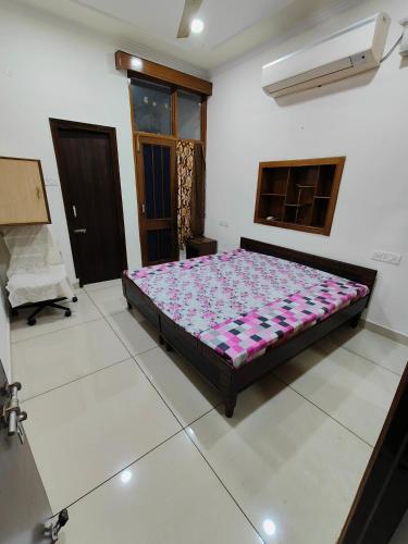钱德加尔Chandigarh home的卧室中间设有一张床