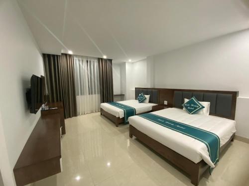 下龙湾Minh Hưng Motel的酒店客房设有两张床和一台平面电视。