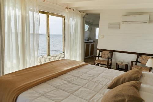 何塞伊格纳西奥Laguna Garzón Lodge的一间卧室设有一张大床,享有海景