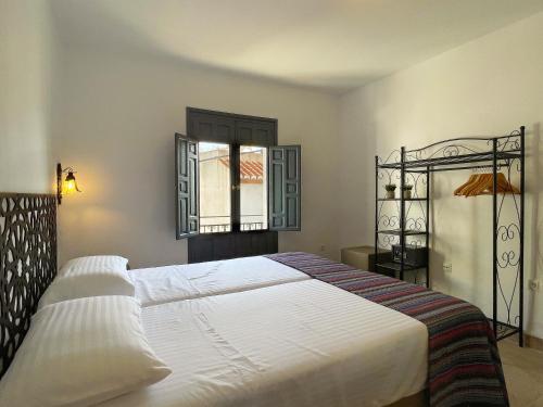 萨各夫雷纳Las Tres Hermanas的一间卧室设有一张大床和一个窗户。