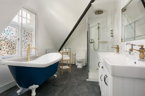 温莎皇家阿德莱德酒店的浴室配有蓝色浴缸和水槽