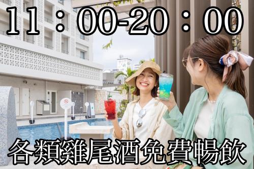 那霸Okinawa Hinode Resort and Hot Spring Hotel的两个女人在游泳池前喝饮料