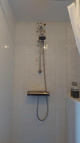 乌得勒支B en B Sluisje 1818的白色瓷砖墙上的淋浴软管