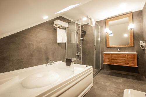 特拉布宗Zanike hotel的带浴缸、水槽和镜子的浴室