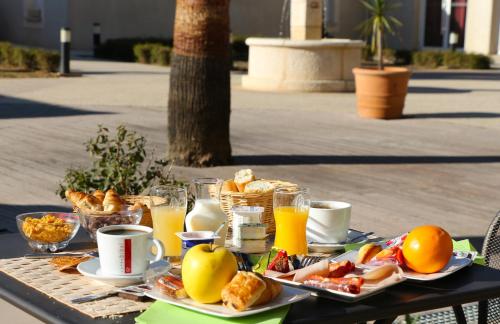 加拉尔盖莱蒙蒂厄雅塞德卡马格酒店的一张桌子,上面有早餐食品和饮料